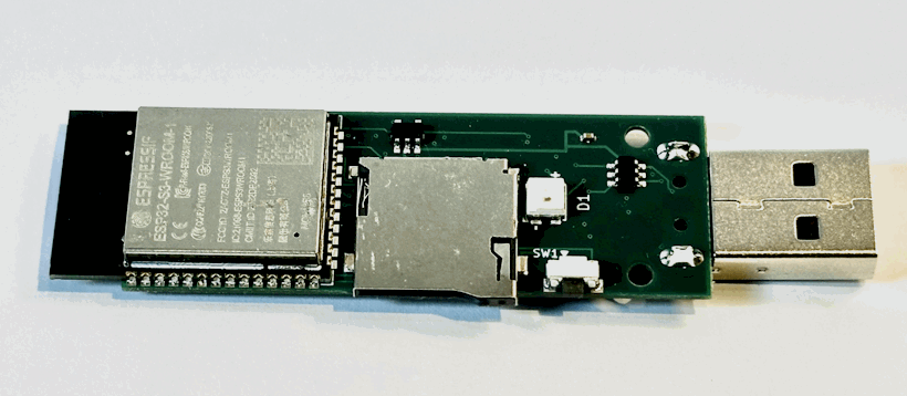 The assembled USB Army Knife circuit board outside its case, with its processor module, microSD slot, controls and USB connector visible